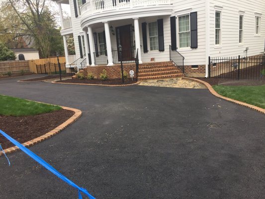 Residential asphalt driveway with decorative brick edging in Richmond Virginia
